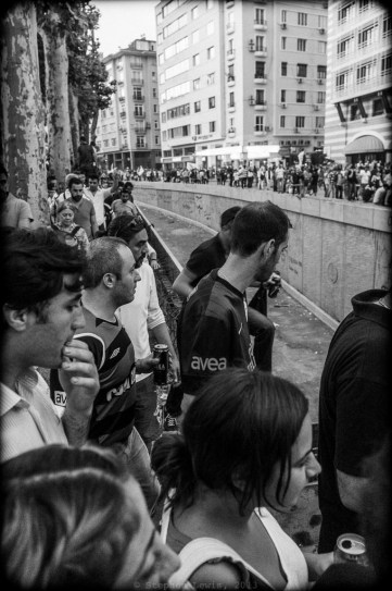 Marchers approaching Gezi Park from Osman Bey and Harbiye; Istanbul, early-June, 2013. In the center, the uncompleted open trench for an automobile underpass under and through Taksim Square, the main element in the road widening project that initially sparked the Gezi Park occupation. (Fuji X100). Click on image to enlarge.