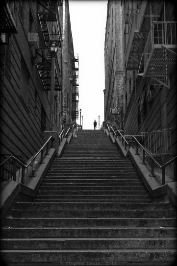 The streets of the west Bronx meander upwards on their ascent to the heights above the Harlem River.  Their winding curves are transected by linear alleyways and stairways that reveal the brash geometry and uncompromising textures that underlies the stylized art deco facades for which the neighborhood is known.  Anderson Avenue, 2012. (FujiX100) Click to enlarge.