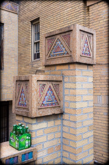 Detail, Service Entrance, Mayan-inspired terracotta tiles, Park Plaza Apartments, Jerome Avenue, Highbridge Heights, Bronx, New York.  Constructed: 1929-1931.  Architects: Horace Ginsbern, Marvin Fine. The six-pack of Heineken is fortuitous.  2012. (Fuji X100). Click to enlarge.